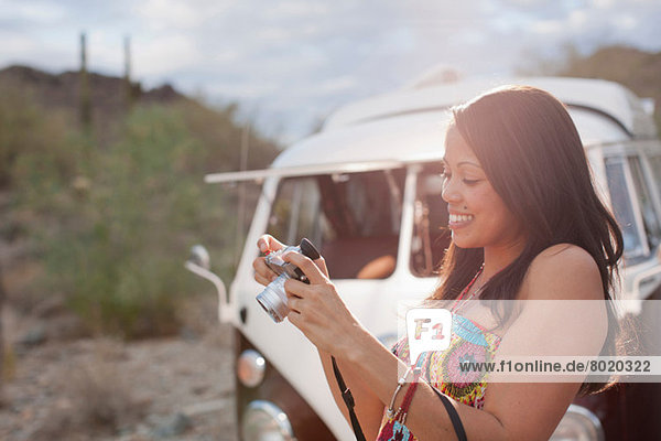 Young woman looking at camera on road trip  smiling