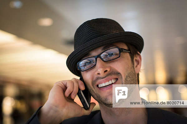 Close up portrait of mid adult male on mobile phone