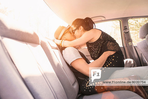Couple in car  kissing