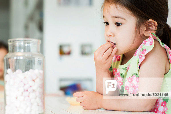 Close up of young girl tasting marshmallows