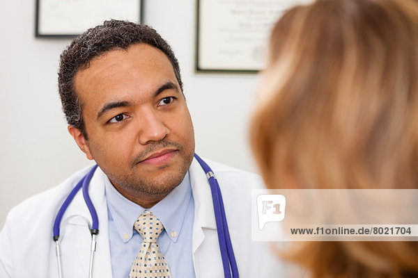 Mature doctor listening to patient