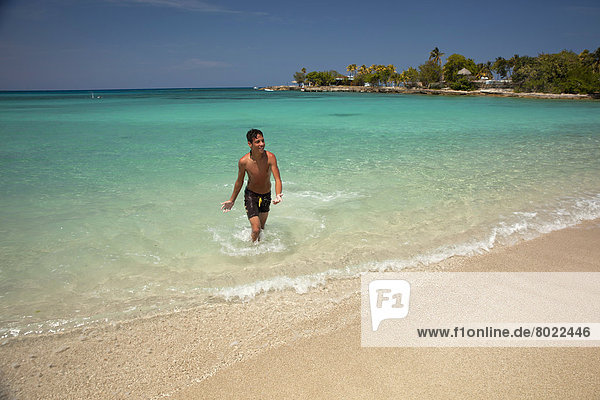 Young Cuban man on Playa Bacuranao beach