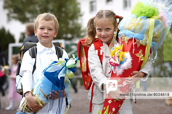 Children with gift cones on their first day of school.