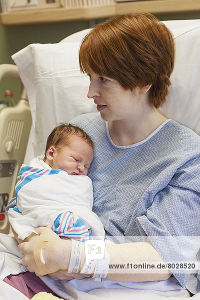A mother holds her newborn baby in a hospital bed Willimantic connecticut united states of america