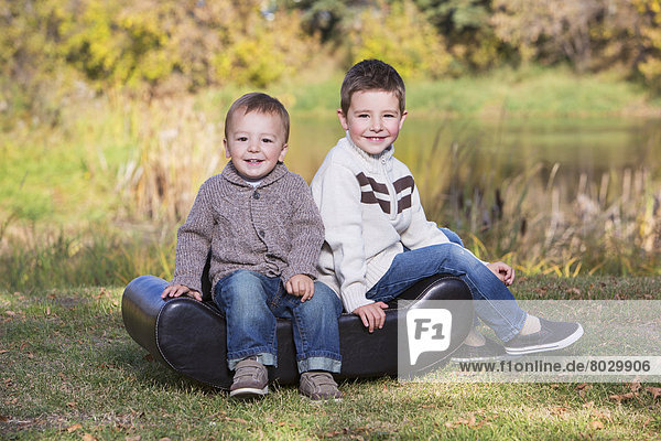 Portrait of two young boys in a park in autumn St. albert alberta canada