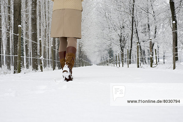 A woman walks down a snowy path in winter Locarno ticino switzerland