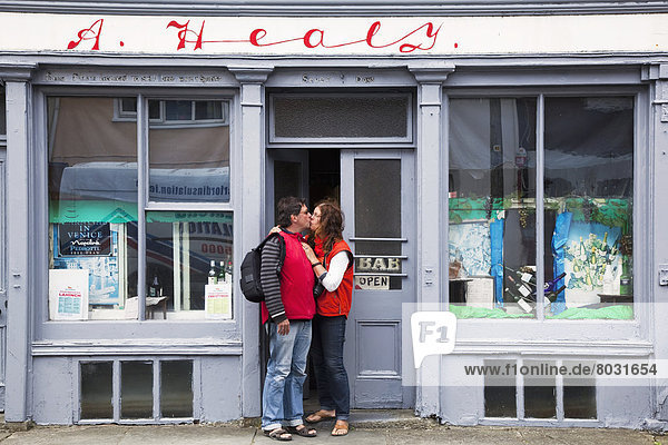 A couple kissing in the doorway of a shop Ennistymon county clare ireland