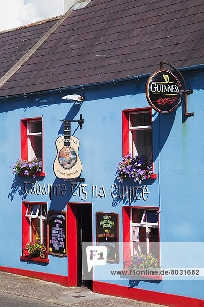 A colourful pub in a blue and red building Dingle county kerry ireland