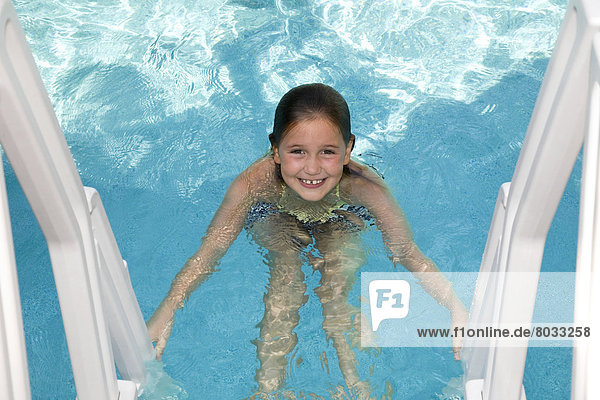 Young Girl Climbing A Swimming Pool Ladder  Ontario Canada