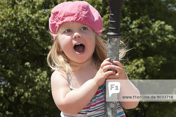 Young girl laughing and playing in a park in summer Ontario canada