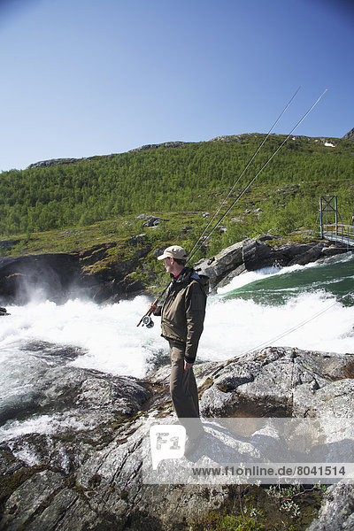 Man fly fishing  Miekak  Lapland  Sweden