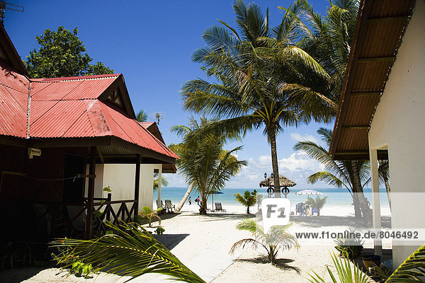 Beach huts on white sandy beach with palm trees  Pantai Cenang (Cenang beach)  Pulau Langkawi  Malaysia