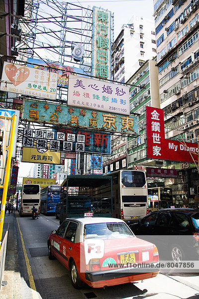 Streets bustle with taxis and buses  Kowloon  Hong Kong  China