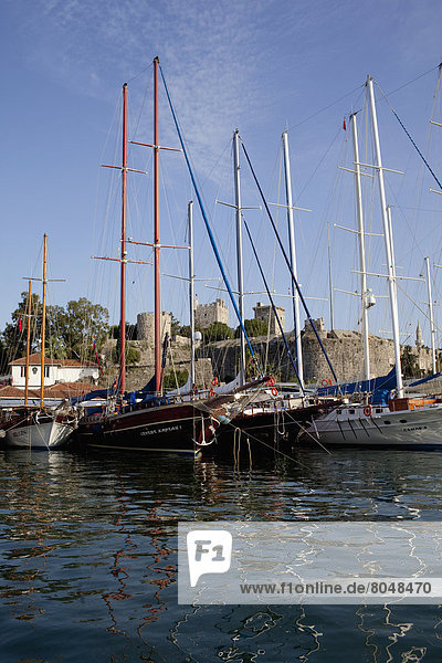 Turkey  behind is Bodrum castle  Bodrum  Gulet boats lined up in harbour of Bodrum bay