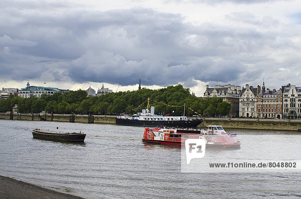 Tourboat and HMS President warship on Thames river  London  England  United Kingdom