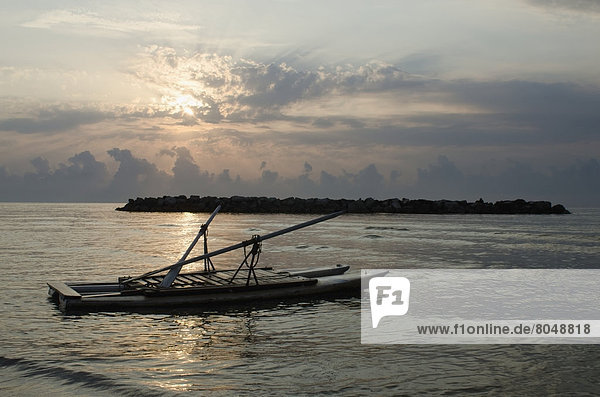 Floating raft on calm sea at sunrise with clouds and rocks  Porto San Giorgio  Marche  Italy