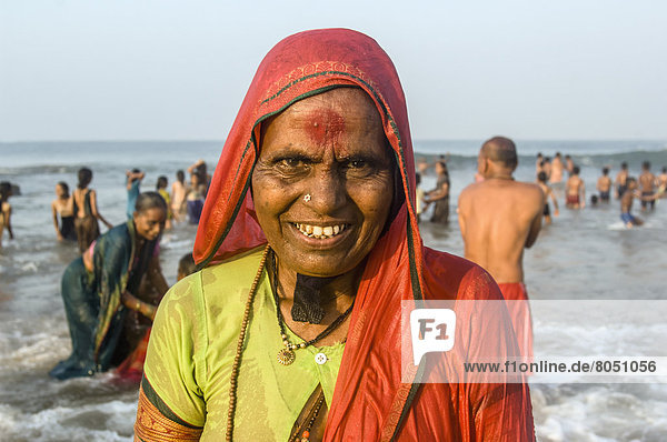 India  Karnataka  Portrait of Indian woman on beach full of pilgrims  Gokarna
