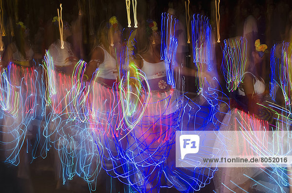 Ladies parading and waving flash torch led wands  London  UK