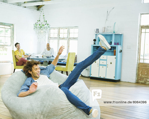 Man jumping into beanbag chair