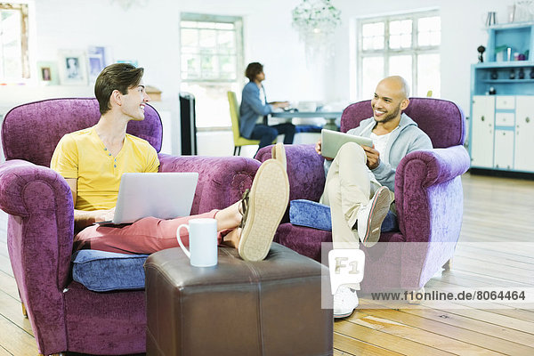 Men relaxing together in living room