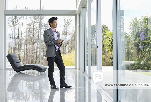 Businessman standing at office window