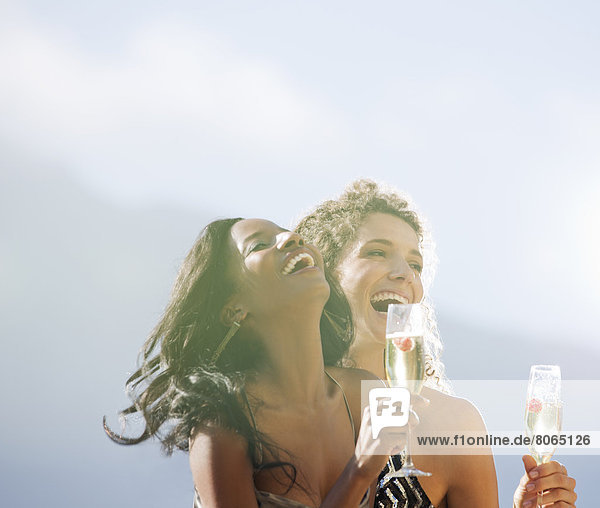 Women drinking champagne together outdoors