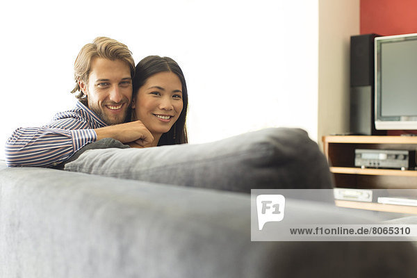 Couple relaxing together on sofa