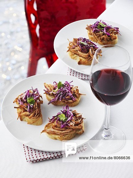 Crostini topped with pork and red cabbage