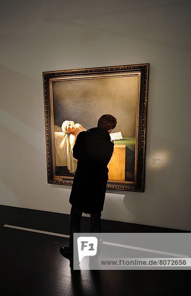 'Someone looking at the painting called The Death of Marat (French: ''La Mort de Marat'') by David 1793 at the Centre Pompidou-Metz (57). This is the first time ever that a national cultural institution is decentralised in France this arts centre is the first decentralised branch of Centre Pompidou with a part of the huge collection of the National Museum of Modern Art'