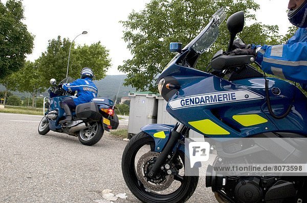 Drome department (26). 2011/06/30. Road check by the National Gendarmerie on the minor road / B road RD 532. Road safety. In the foreground  two motorcycle gendarmes moving away from the road shoulder