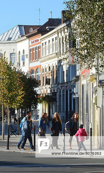 'Building facades in downtown Tourcoing  in the street ''rue de Tournai'' (59). Buildings of the city centre with pedestrians'