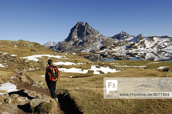 'Hike in the Bearn (former province of France)  ''Pic du Midi d'Ossau'' (Lake Ayous  Lake Gentau) in the Pyrenees-Atlantiques department (64). Woman carrying a backpack  on a path'