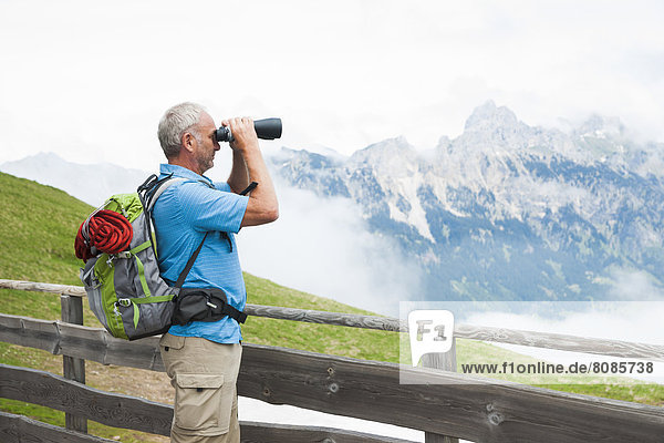 Hiker with binocular  Neunerkoepfle  Allgaeu Alps  Tannheim Valley  Tyrol  Austria  Europe