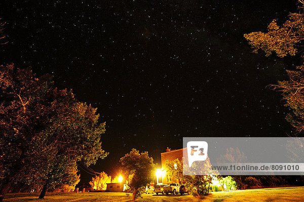 Starry sky over a small village in the middle of the prairies