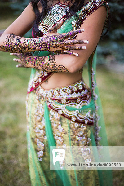 Woman wearing traditional Indian henna and robes
