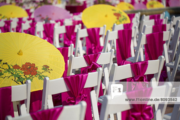 Parasols and silk scarves on chairs outdoors