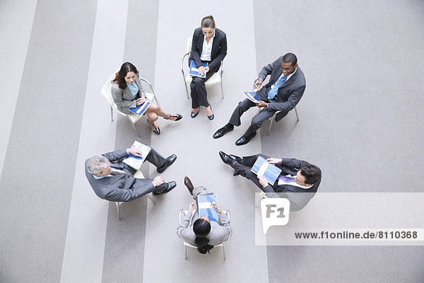 High angle view of business people sitting in circle