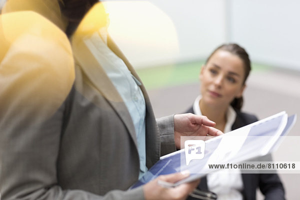 Businesswoman holding paperwork in meeting
