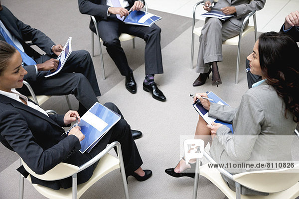High angle view of business people meeting in circle