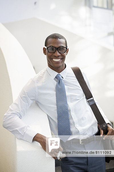 Portrait of smiling businessman on staircase