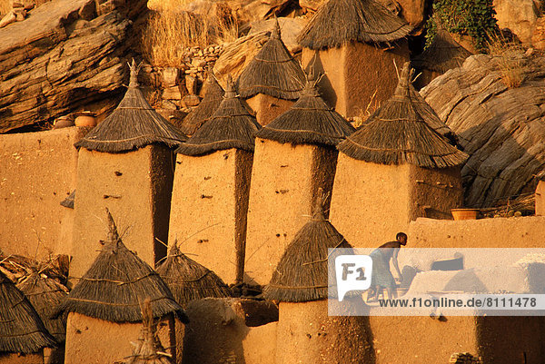 Africa African Ethnicity Brown Color Image Culture Custom Day Dusk Dwelling Full Frame Full Length Horizontal House Hut Mali Dogon Tribe One Person Outdoors Photography Thatched Roof Tribal Unknown Age Village Protection Tradition Travel Destinations