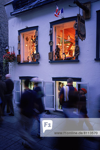North America USA Canada Street Wall Windows Flags Show Room Flowers Leaves Ivy Statue Shop Footpath Small Group Of People Walking Casuals Town Corner Fast Elegant Outdoors Day Side View Blurred Vertical Color Image Photography