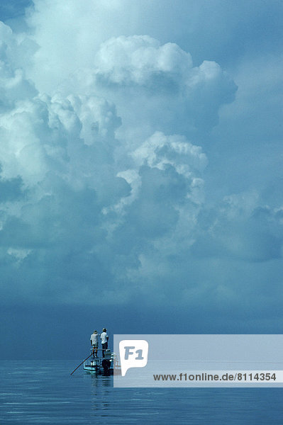 Florida fishing Ocean Tarpon Boat Teamwork Partner Isolated Tranquil Blue Calm Two People Full Length Cloud Stranded Rear View Vertical Outdoors Day Color image Photography