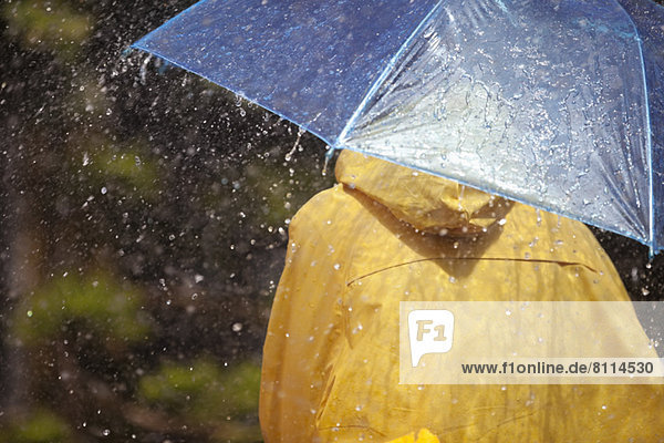 Woman under umbrella in rain