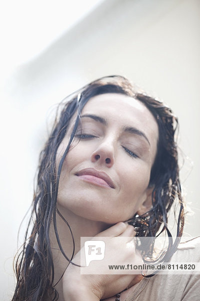 Close up portrait of serene woman with wet hair