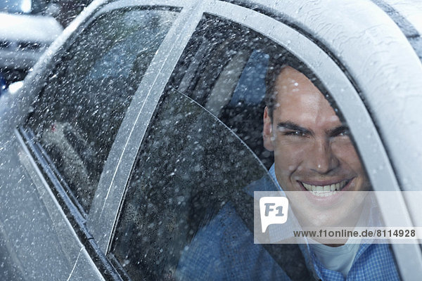 Portrait of smiling man in car