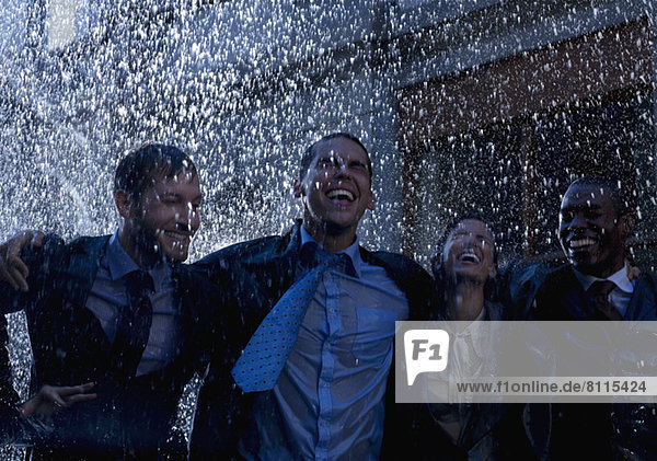 Enthusiastic businessmen in rain