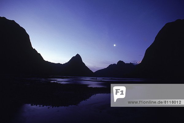 New Zealand Fiordland Mountains Sky Water Fjord Moon Full Moon Silhouette Hills Pond Lake Reflection Ranges Nobody Still Landscape Nature Cool Tranquil Calm Remote Solitude Outdoors Night Distant Horizontal Panoramic Color Image Photography