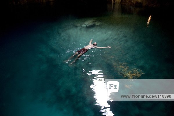 Cave Cenote Color Image Day Full Length Geology High Angle View Leisure Activity Limestone Mexico Natural Landmark Natural Phenomenon One Person One Young Man Only Outdoors Photography Physical Geography Recreational Pursuit Rock Rock Formation Shirtless Sink Hole Swimming Swimming Shorts Swimwear Travel Destinations Vacations Water Young Adult Yucatan Vignette Horizontal outdoorcollection