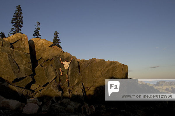 alone one person man rock rock climbing bouldering scenic serene climb cliff coast horizontal color image photography daytime outdoors outdoorcollection